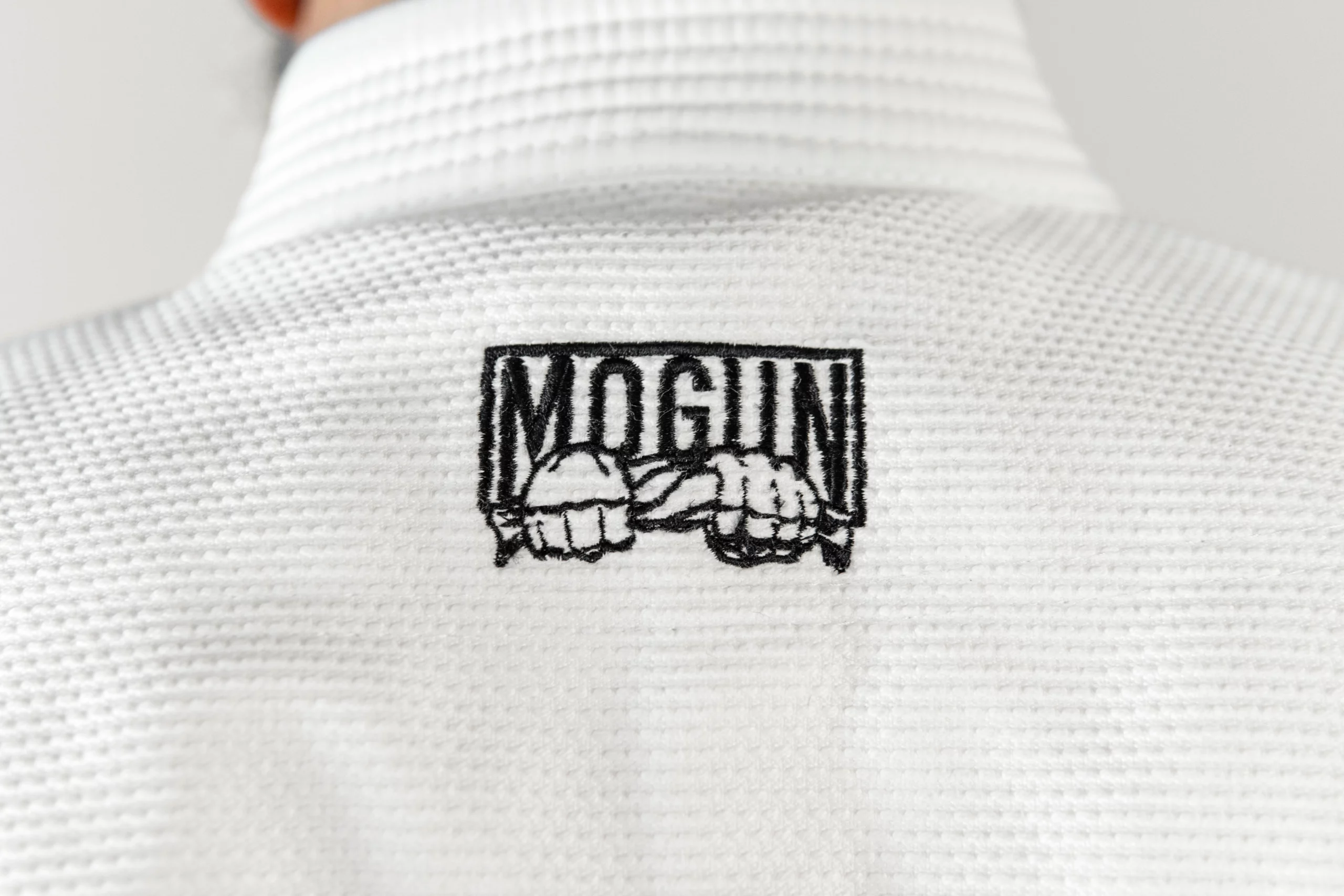 Mogun JJB Gi Komp V1 Blanc logo close-up 2